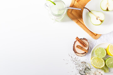 Aesthetic minimalist composition. Glass with green lemonade on white background. Summer cold drink concept.