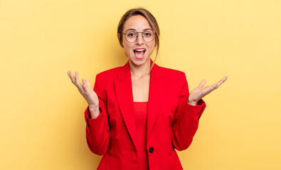businesswoman feeling happy and astonished at something unbelievable