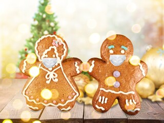 Fototapeta premium Stay home quarantine from Covid-19. Christmas gingerbread men with a masks
