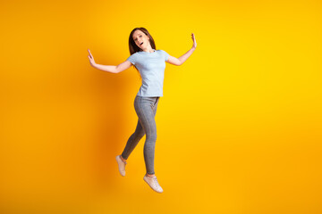 Fototapeta na wymiar Full size profile side photo of young pretty girl go walk jump elegance isolated over yellow color background