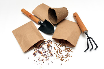 Top view of the seeds for planting and garden supplies on a white background. The concept of bio gardening, horticulture, cultivation of vegetables and herbs