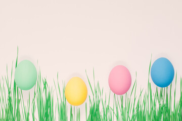  Creative  Easter composition of  colorful eggs and grass. Flat lay minimal background.