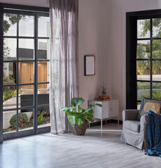 Modern home corner decoration with armchair pillow and blanket style, garden view, vase of plant, interior decor.