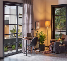 Modern rom with working table and armchair style, parquet floor, frame lamp decor, curtain, garden view house interior.