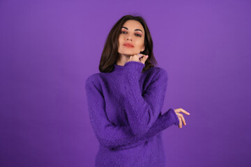 Young woman in a purple soft cozy sweater on the background of cute smiling cheerfully, in high spirits, confident smile, bright makeup with lipstick