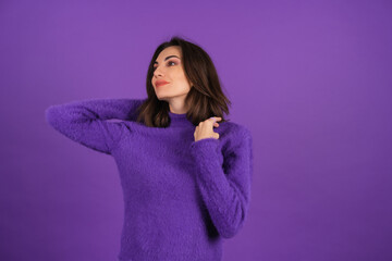 Young woman in a purple soft cozy sweater on the background of cute smiling cheerfully, in high spirits, confident smile, bright makeup with lipstick