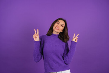 Young woman in a purple soft cozy sweater on the background of cute smiling cheerfully, in high spirits, confident smile, bright makeup with lipstick