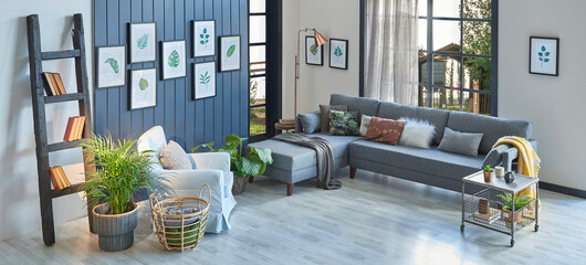 Modern blue room, grey sofa, yellow blanket and leaf frame, lamp, home decoration and parquet style.