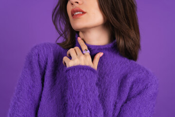 Young woman in a purple soft cozy sweater on the background of cute smiling cheerfully, in high...