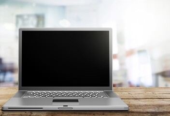Fototapeta premium Blank display screen laptop computer on white wood table. Modern cozy comfortable home living room