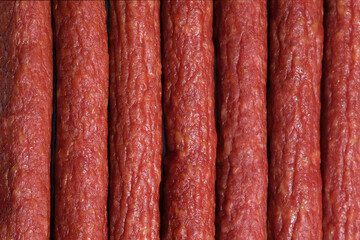 Smoked sausage thin top view. Hunting sausages close up background. Lots of smoked sausage. Meat to beer snacks.