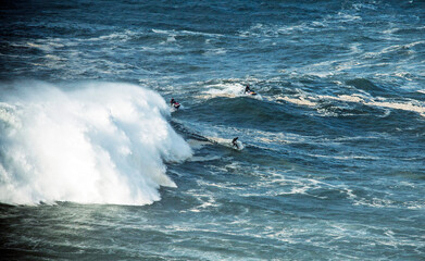 Surfing big waves off the coast of Nazaré, Portugal