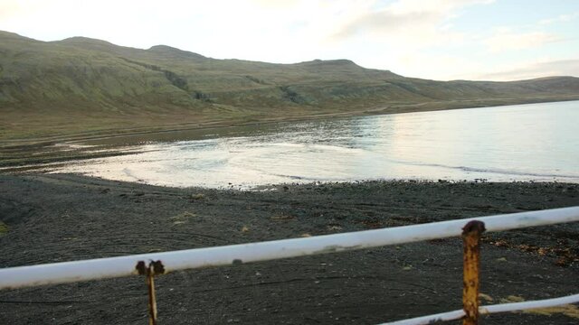View from the hull of a shipwreck on the coast and ocean, hills in the background in Iceland