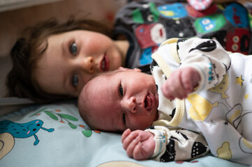 A young girl and her newborn brother.