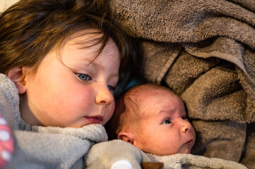 A young girl and her newborn brother.
