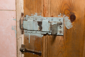 A huge homemade deadbolt lock on the door of the production room.