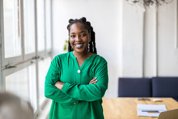Portrait of a smiling creative woman in a modern loft office
