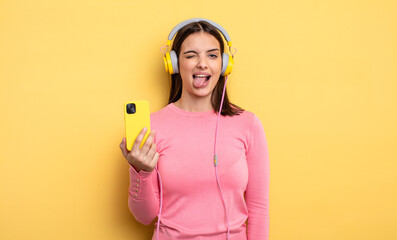 pretty woman with cheerful and rebellious attitude, joking and sticking tongue out. listening music...