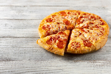 Tasty hot homemade pepperoni pizza. Traditional classic pizza with salami and cheese. With copy space for text.