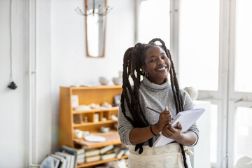 Woman pottery artist working in her art studio
