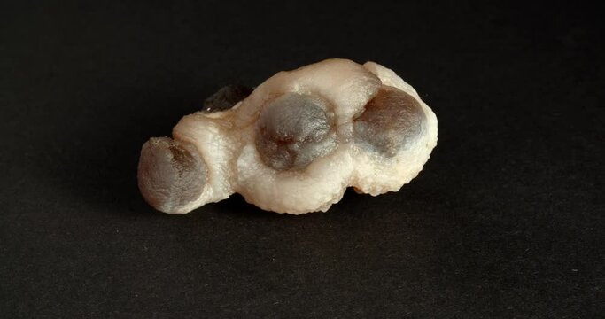 Rotation of chalcedony Morocco. Close-up on a black background.
