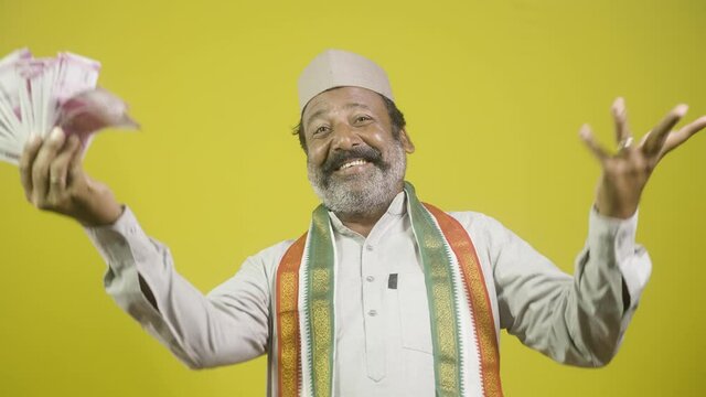 Corrupt greedy indian politician laughing by using money like a fan - concept showing of political arrogance, evil laughter and unprofessional way of money making