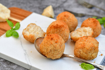 Italian arancini Cacio e pepe. Home-made rice balls with mozzarella cheese, parsley, lemon, and parmesan cheese.