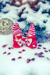 Christmas toys stand on the branches of a snow-covered fir tree
