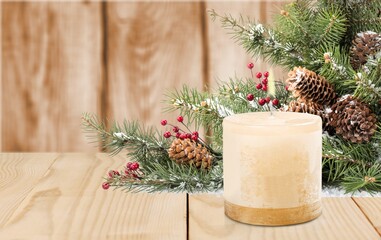 Fir branch with Christmas tinsel and candle. Christmas and New Year festive background.