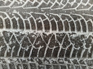 car tire tracks in the snow closeup photo.