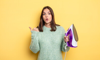 pretty woman looking astonished in disbelief. iron clothes concept