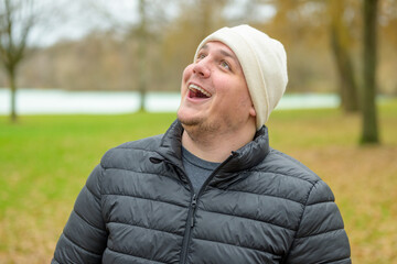 Aghast young man staring up in amazement with open mouth