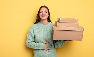 pretty woman laughing out loud at some hilarious joke packages boxes concept