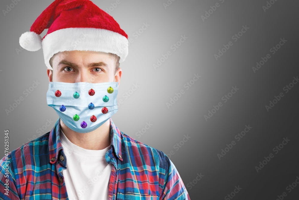 Poster Adult surprised man in Christmas decorated mask celebrate xmas holidays at home because coronavirus. New normal, social distancing