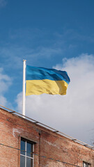 Ukrainian flag over the school in the centre of the city