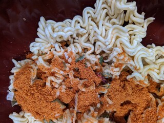 dry instant noodles with ingredients closeup photo top view.