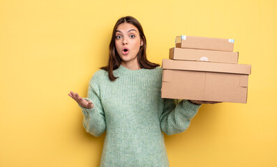 pretty woman amazed, shocked and astonished with an unbelievable surprise packages boxes concept