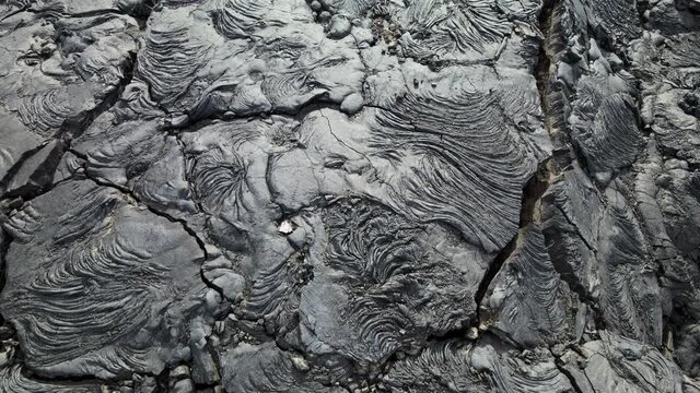 Chain of Craters Road in Hawaii Volcanoes National Park is vivid with blue ocean, waves and black sea cliffs. Cliffs were formed when Mauna Ulu exploded liquid lava.