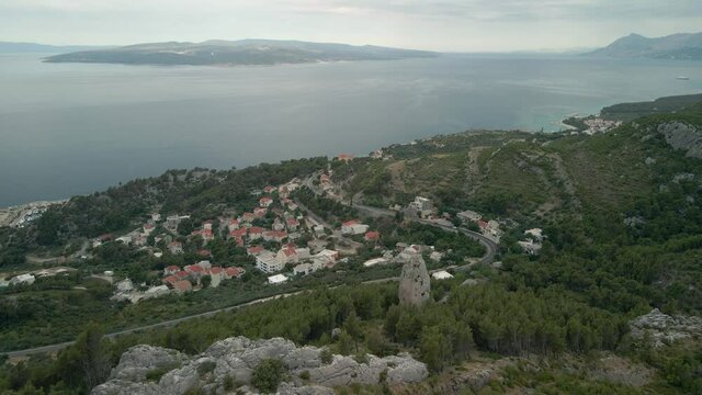 Aerial view of the island of Brac, the town of Krvavica. In the frame is a large stone called Babin zub. Croatia Makarska Riviera aerial view.