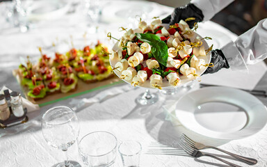 waiter holds plate with food. Restaurant service. buffet or catering.