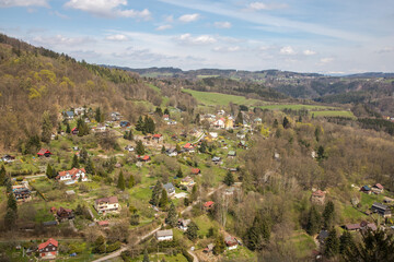 Fototapeta na wymiar view of the foothill village under the rocks during early spring