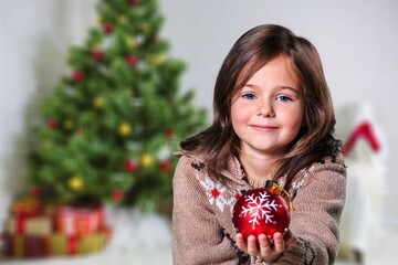 Young girl decorating a Christmas tree, Coronavirus and Christmas concept, beautiful holiday background