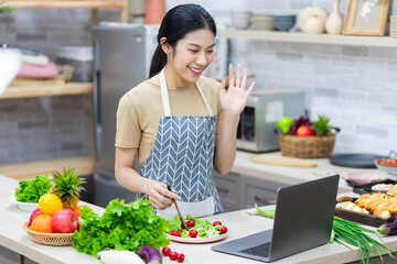 image of asian woman preparing salad in the kitchen