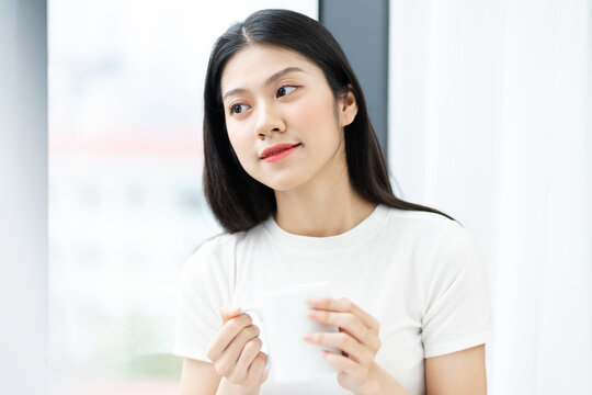 portrait of asian girl drinking morning coffee