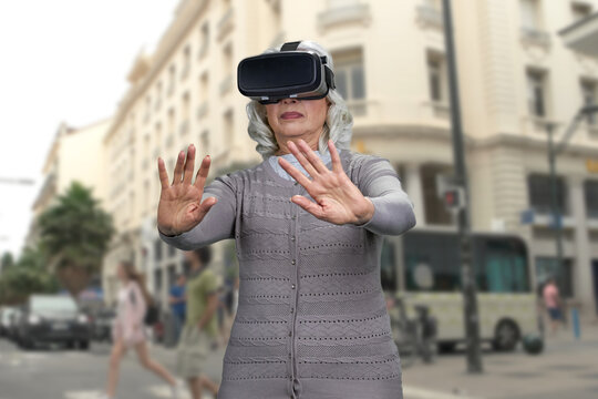 Old lady shocked experiencing virtual reality headset.
