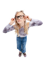 High angle view of beautiful little girl, kid in casual clothes having fun, posing isolated on gray studio background.