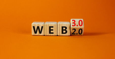 WEB 2.0 or 3.0 symbol. Turned a wooden cube and changed words WEB 2.0 to WEB 3.0. Beautiful orange table, orange background, copy space. Business, technology and WEB 2.0 or 3.0 concept.