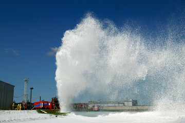 A large jet of fire extinguishing foam. Fire extinguishing of an emergency situation at work.
