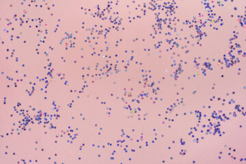 Pink background with small purple holographic sparkles.