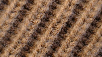 Textile abstract background. Clothing industry concept. Wavy clean material. Fibers of knitted clothes brown white threads. Knitted fabric threads macro